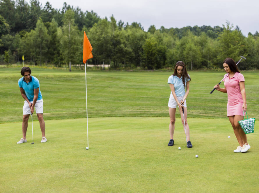 Front view young golfers playing